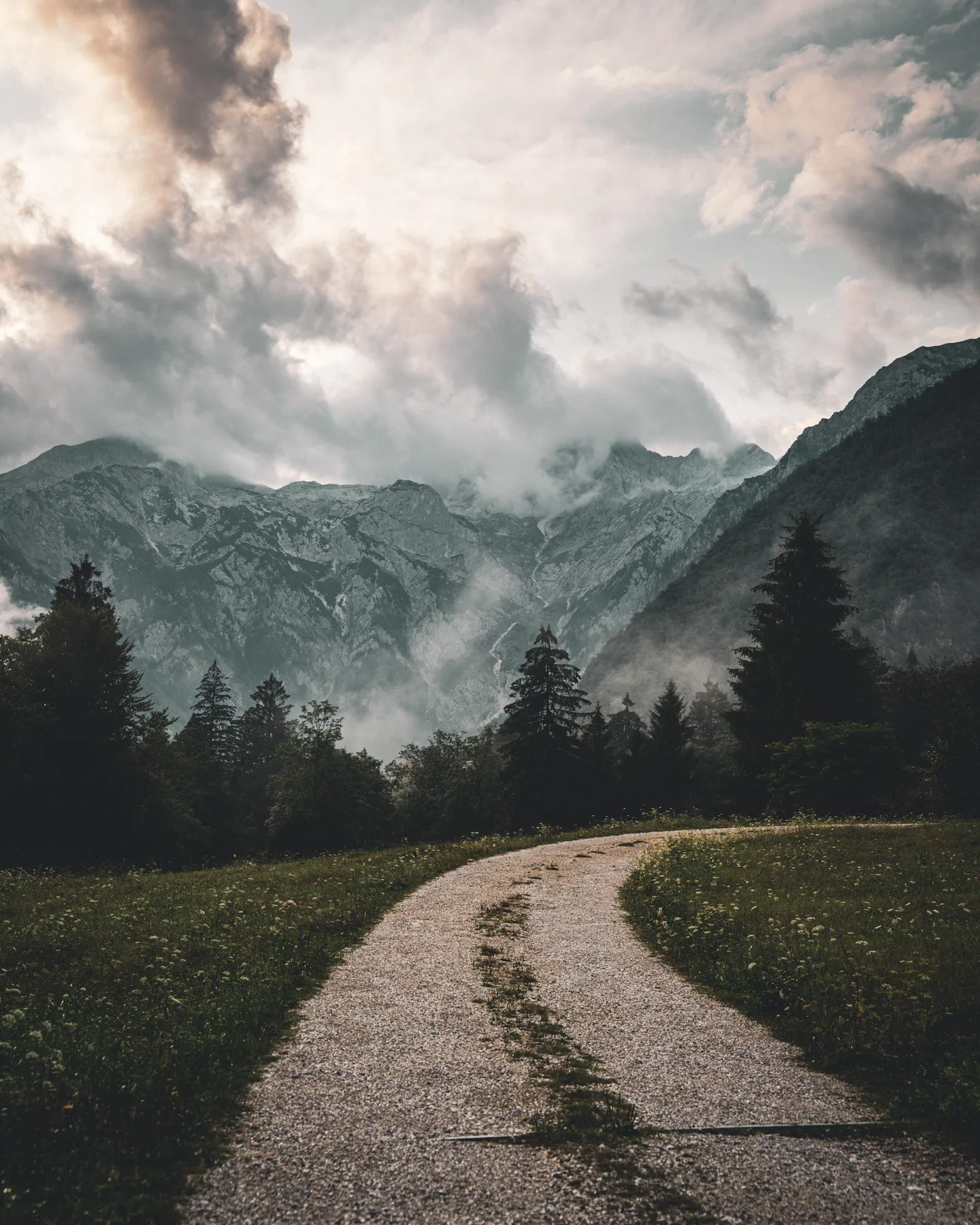 Mountain road beneath a dramatic sky