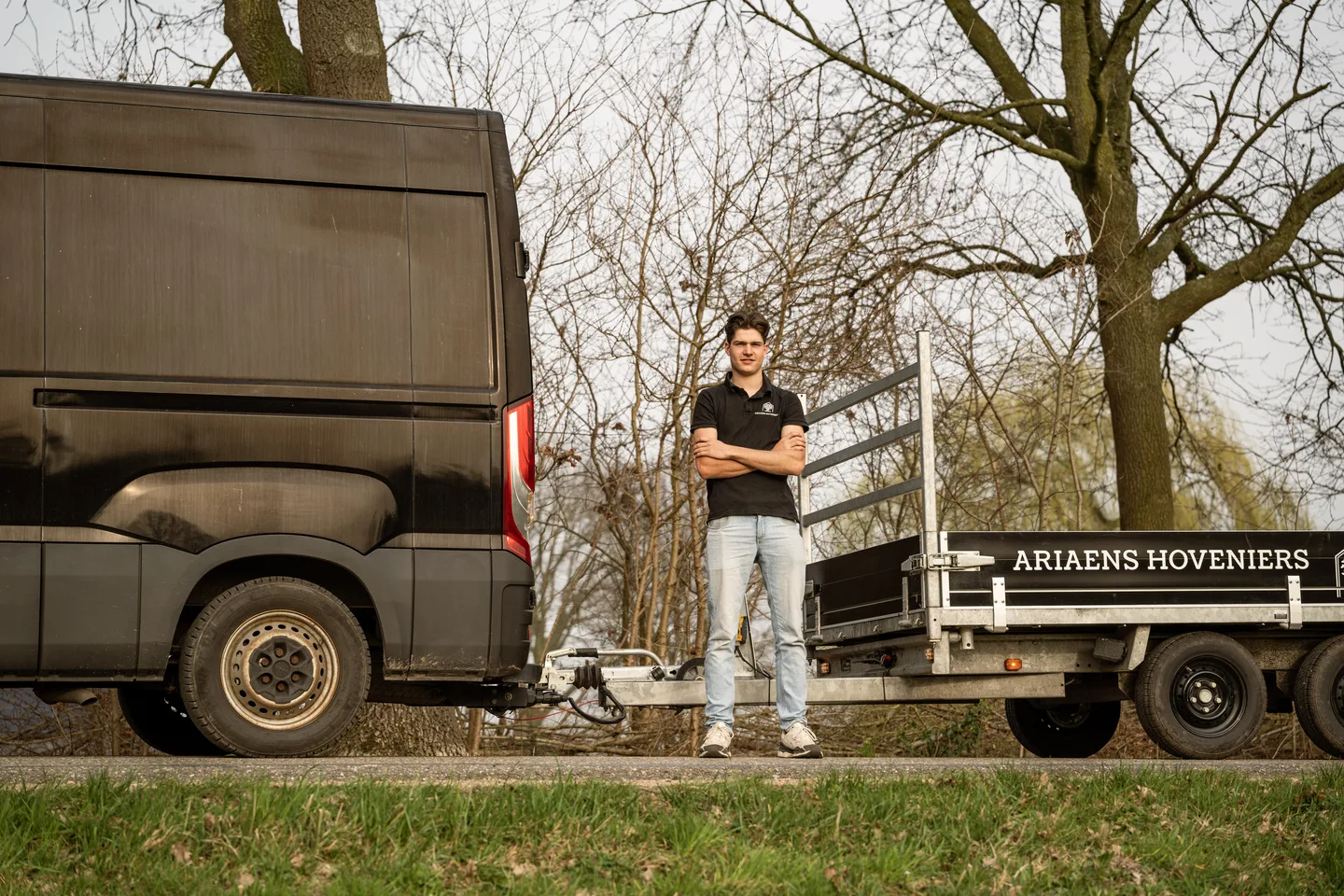 Landscaper beside the work van in a green setting