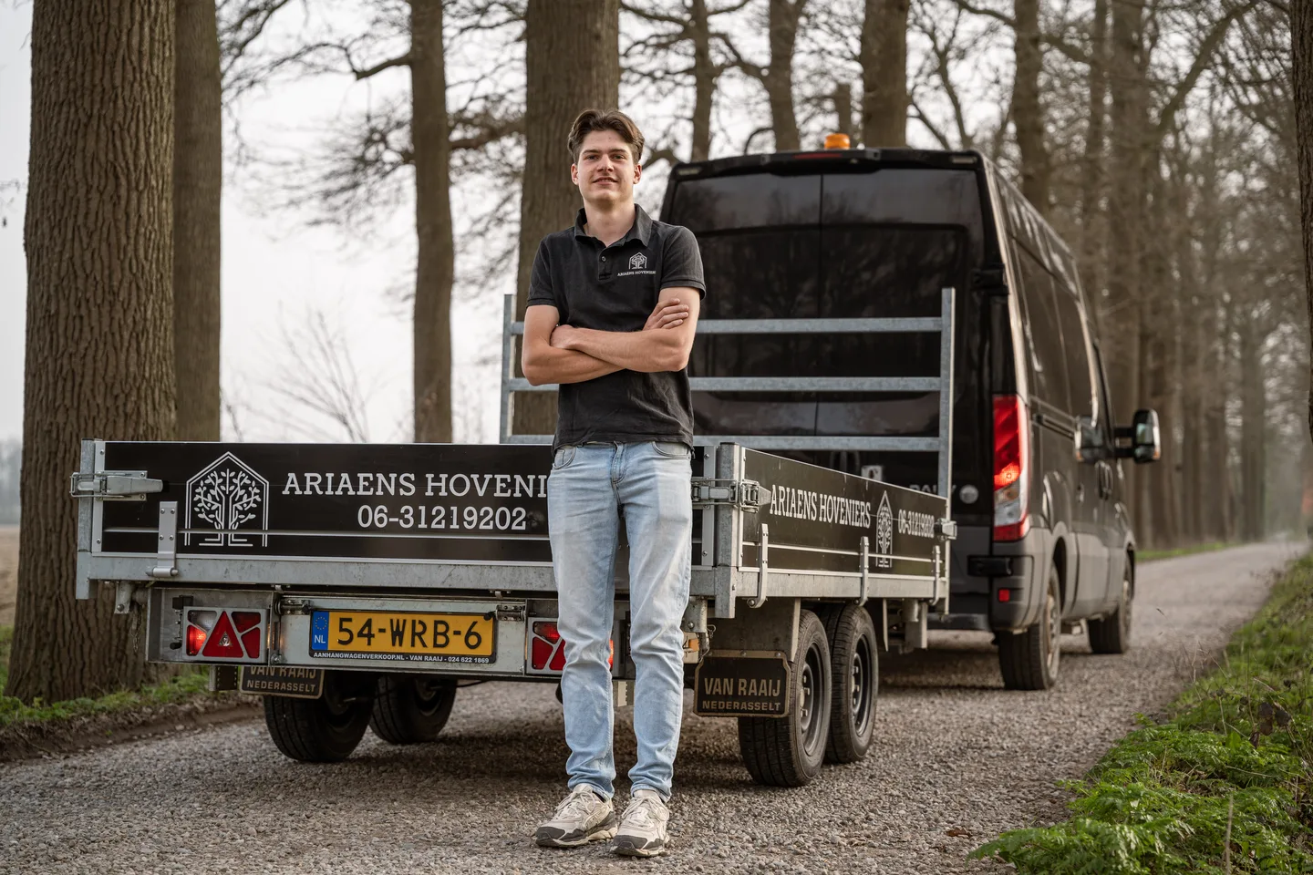 Landscaper in front of the branded work van
