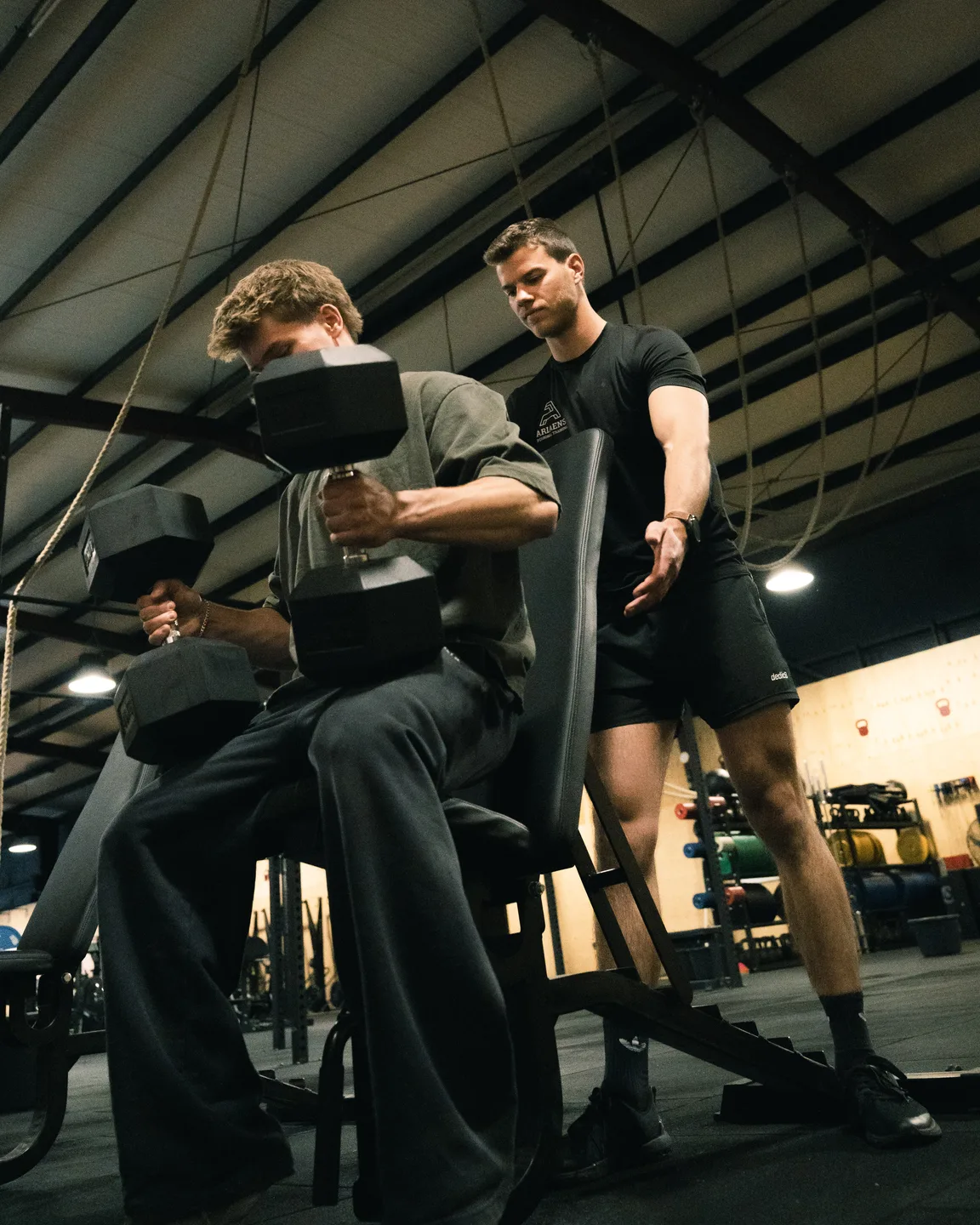 Trainers coaching athletes on the gym floor