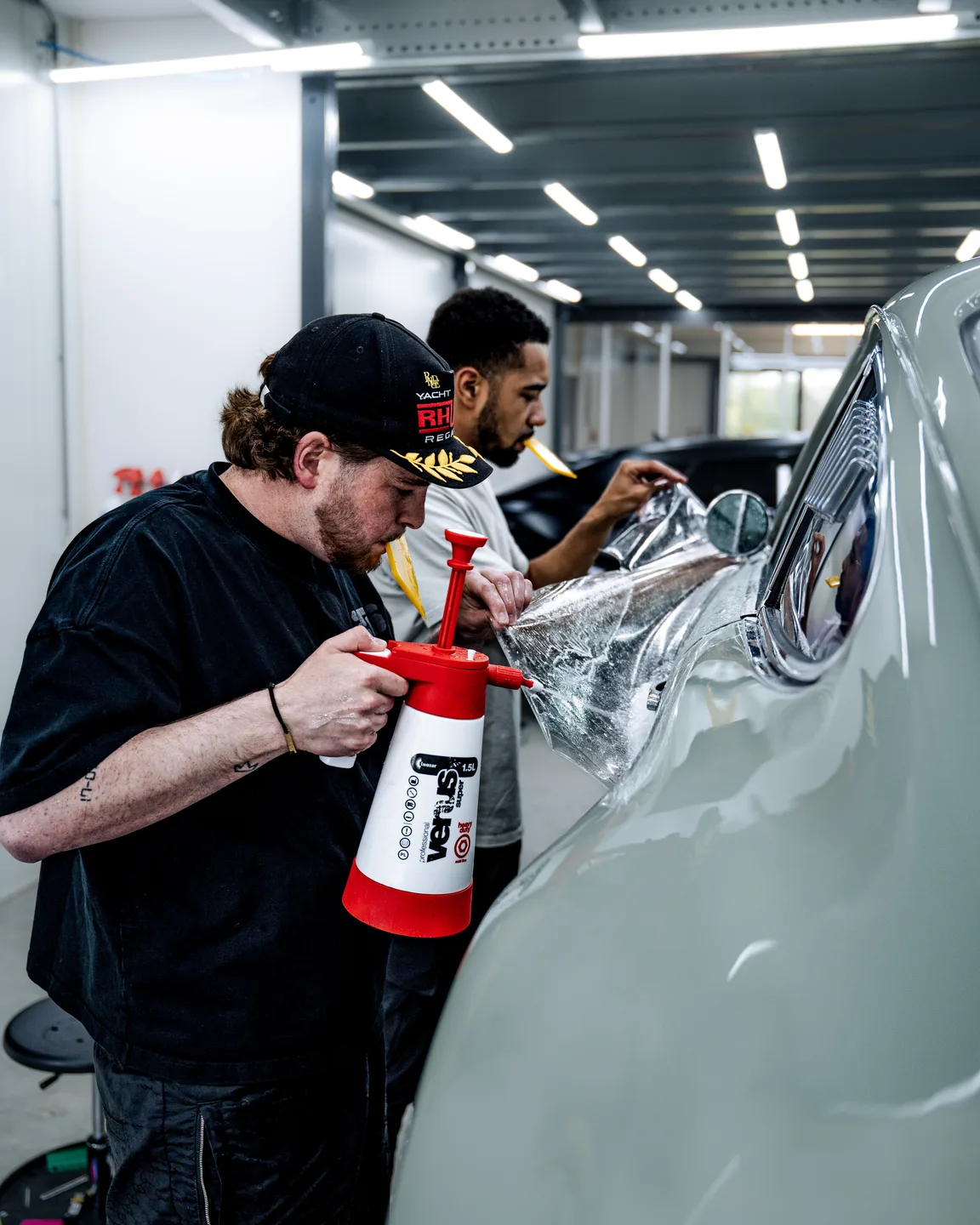 Vinyl wrap being smoothed onto the bodywork