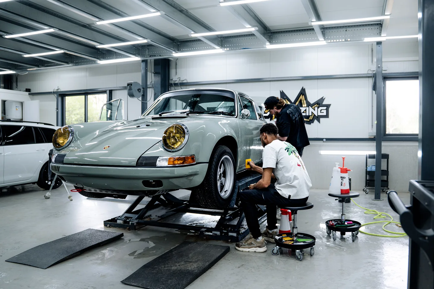 Team gathered around a car in the workshop
