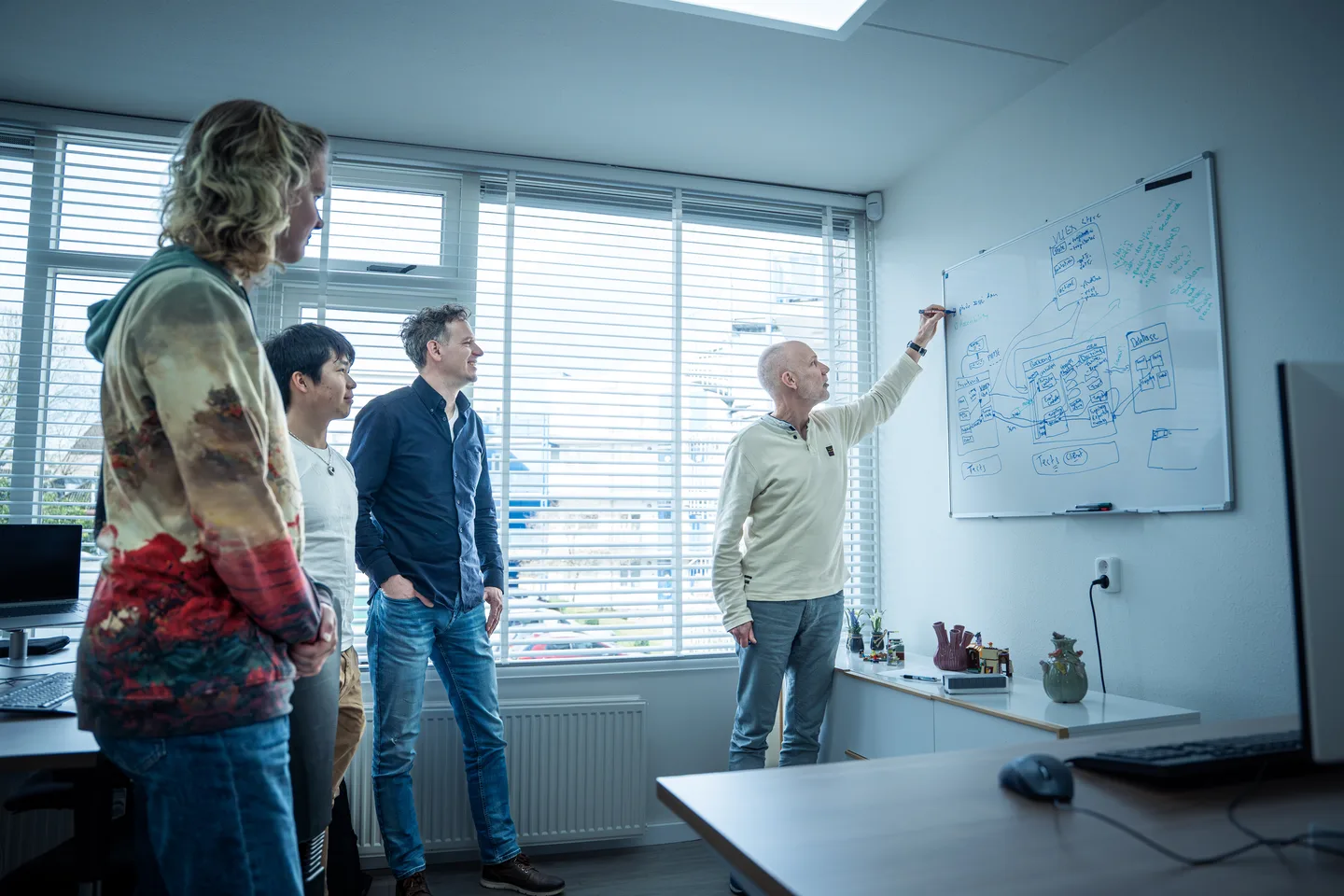 Colleagues in conversation in a bright workspace