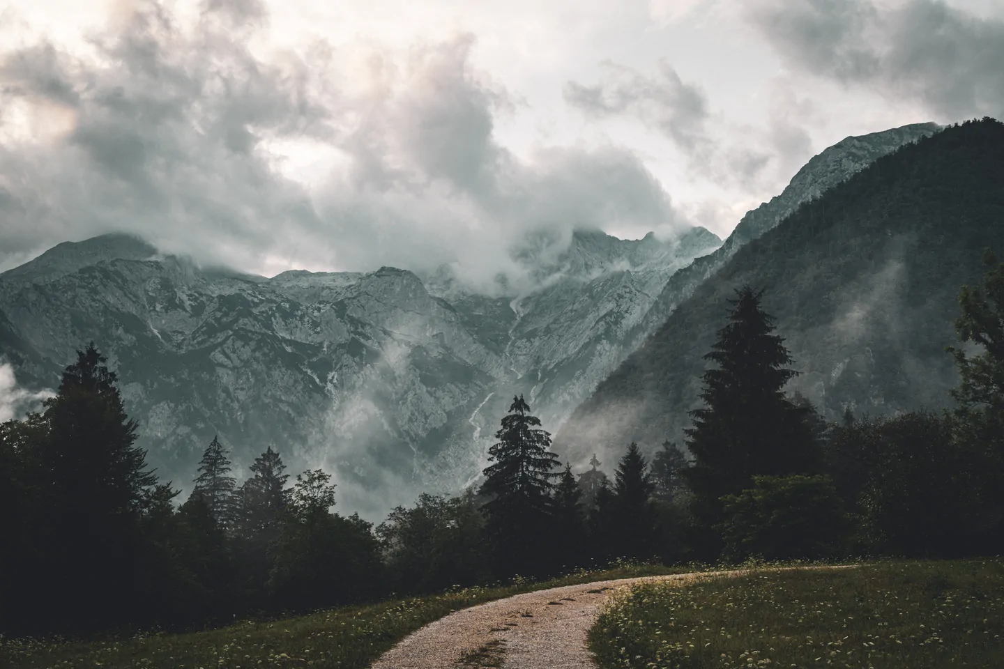Mountain road beneath a dramatic sky