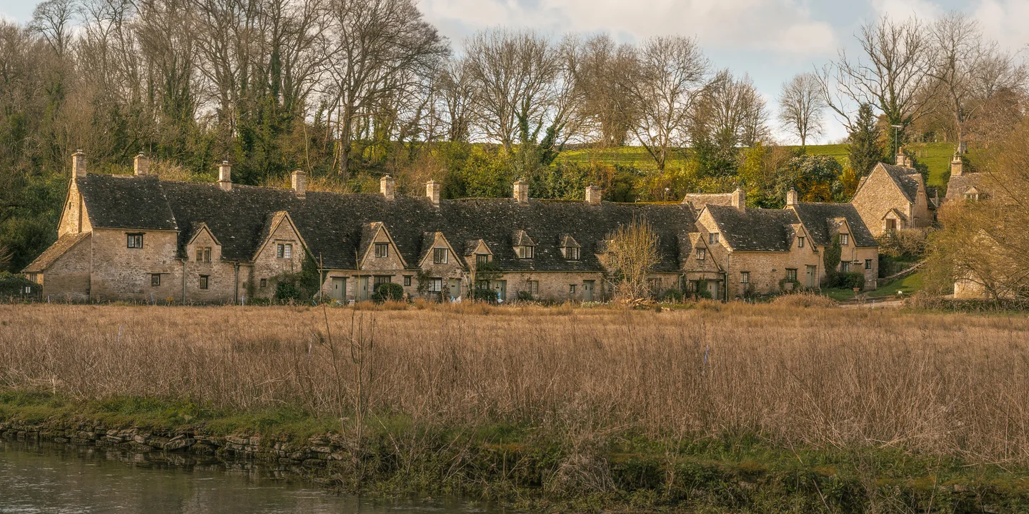 Historic stone houses at the edge of a field