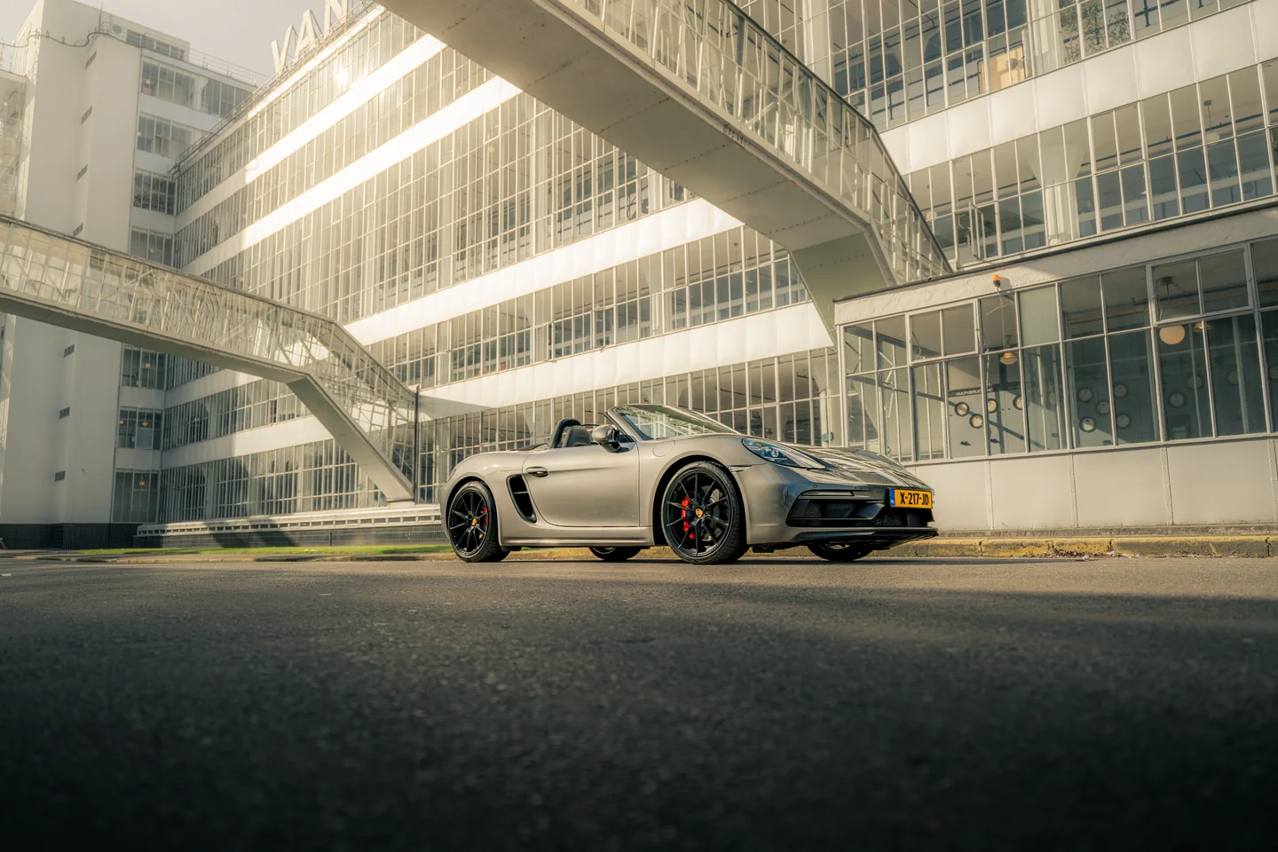 Grey Porsche in front of modern white architecture