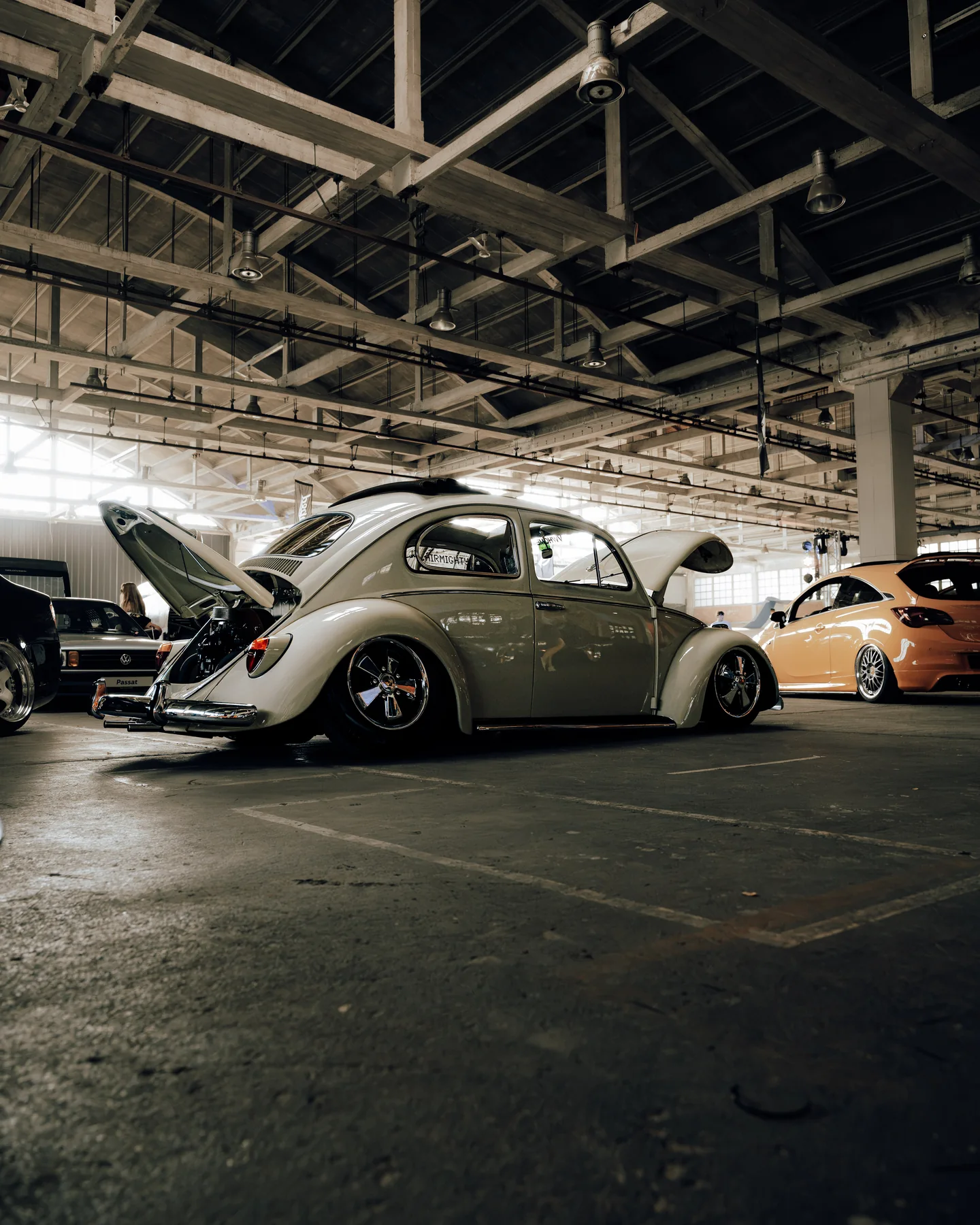 Classic cars displayed inside an event hall