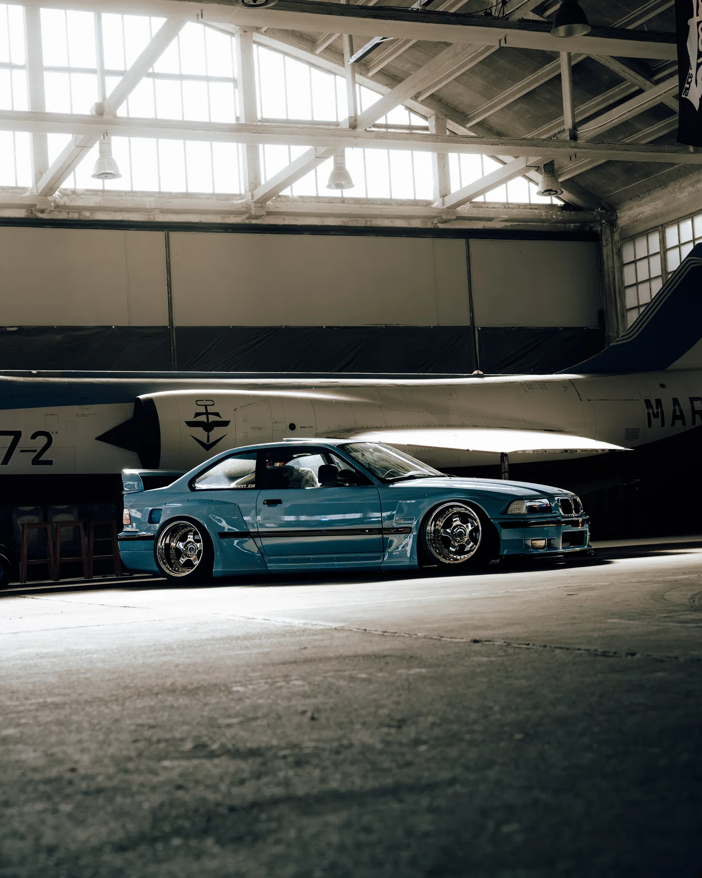 Blue BMW in front of a historic aircraft