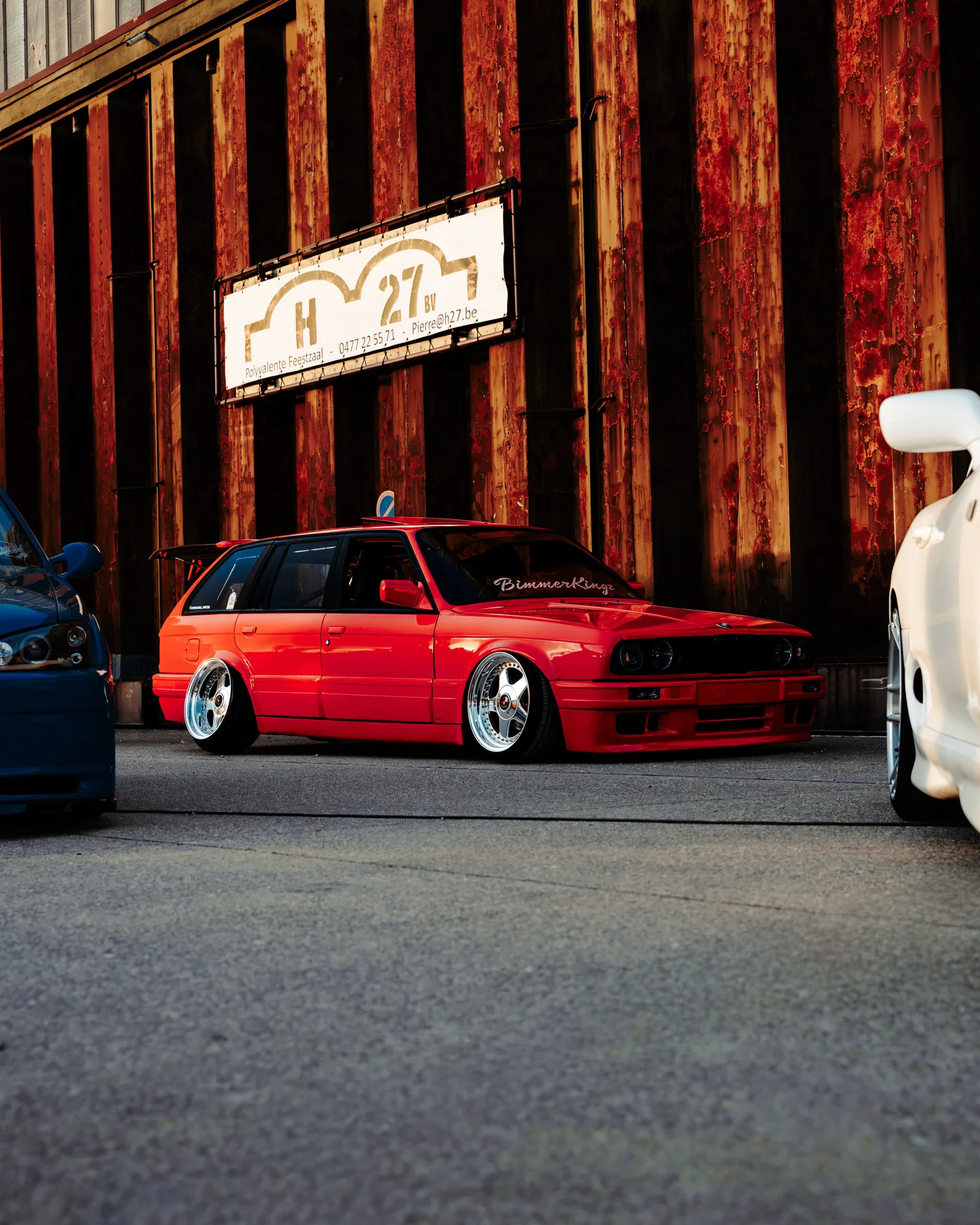 Red classic BMW among other show cars